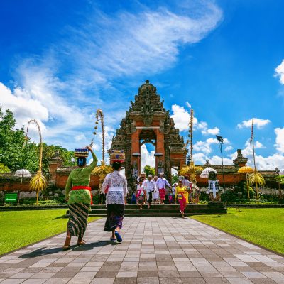 BALI, INDONESIA - APIRL 26, 2017 : Balinese people in traditional clothes during religious ceremony at Pura Taman Ayun Temple, Bali in Indonesia.
